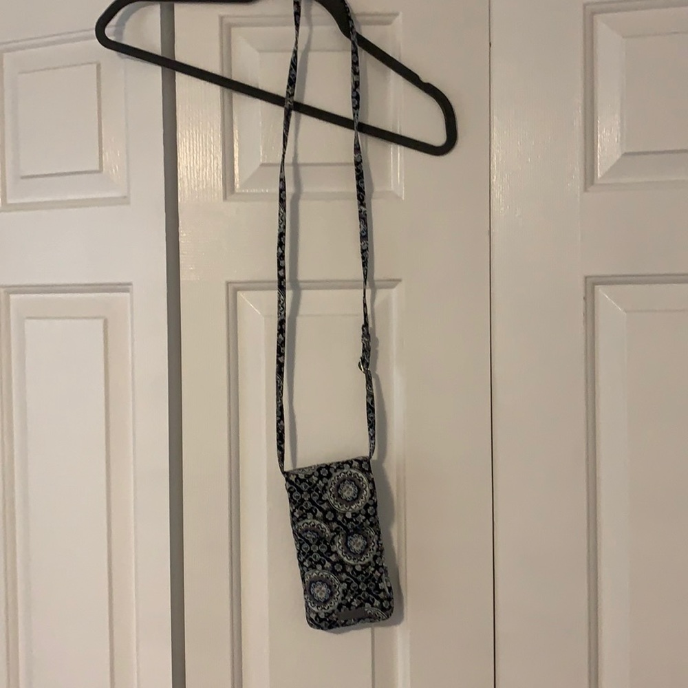 Vera Bradley phone case with adjustable strap and pocket.